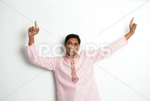 Young indian male in traditional cloths celebrating bhangra Stock Photos