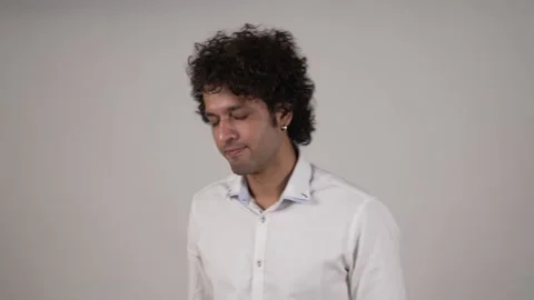 Young Indian man grabbing his head after listening to bad news. Vídeo Stock 169908083