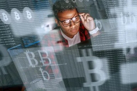 Young indian man mining cryptocurrency at night Stock Photos