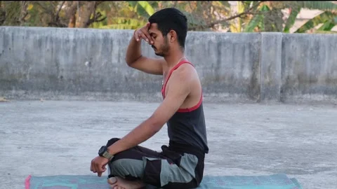 Young Indian man practicing Pranayama breathing technique and meditation Stock-Footage 330390625