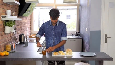 Young Indian man preparing breakfast and girlfriend stolen piece of bread. Stock Footage 119300372