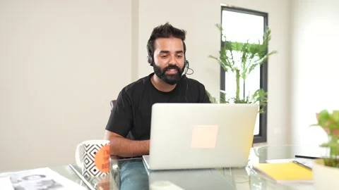 Young indian man speaking in microphone in call center job. customer servic.. Stock Footage 290291900