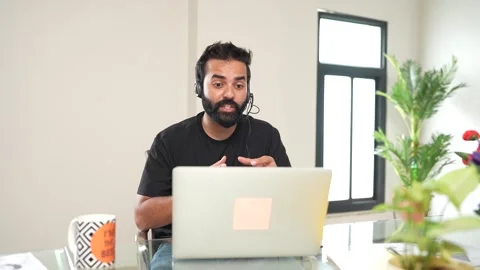 Young indian man talking over microphone taking online class or do virtual .. Stock Footage 290291833
