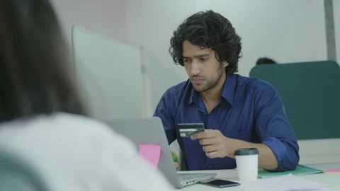 Young Indian man using laptop at home and holding credit card. Stock Footage 163402953