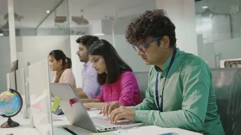 Young indian man using laptop planning for success in modern office. Stock-Footage 168226418