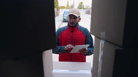 Young indian man using tablet to check delivery order. Loading truck with Stock Footage 152565129