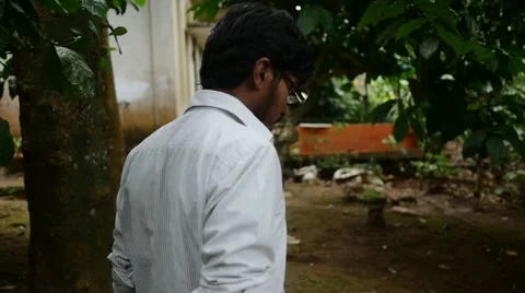 Young indian man walking through jungle to his house Stock Footage 59823875