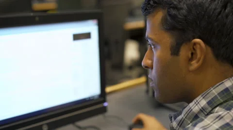 Young Indian man working at computer 4k Stock-Footage 65298202