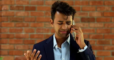 Young Indian professional expressing frustration due to mobile network failure Stock Footage 342693025