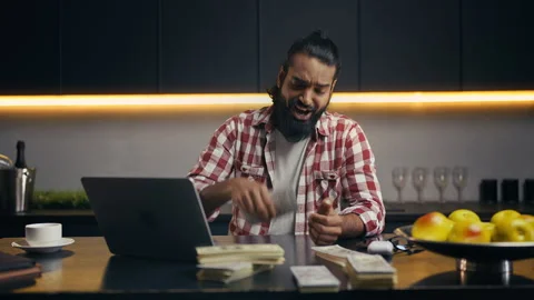 Young Indian programmer counting money, happy with income from IT startup Stock Footage 313281421