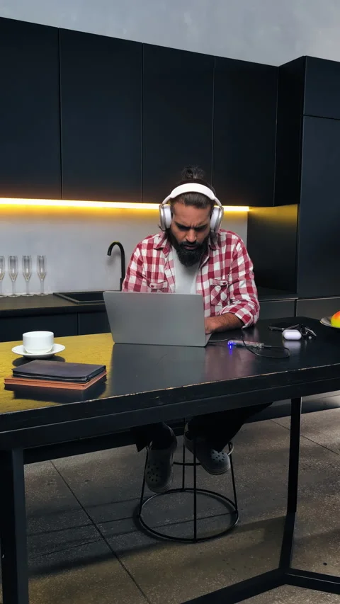 Young Indian programmer in headset testing software project on laptop remotely Stock Footage 316838625