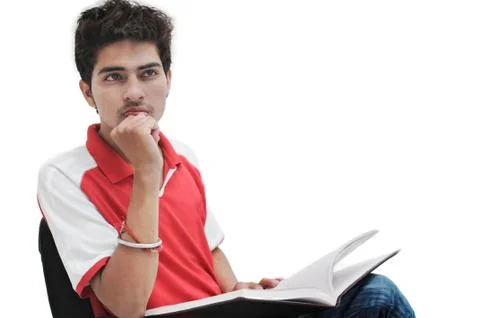 Young indian student thinking, while concentrating on a lecture. Stock Photos