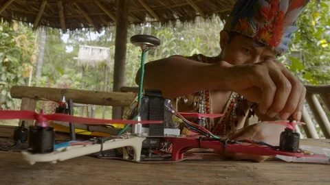 Young indigenous man is manually screwing a wing to his newly build drone medium Stock Footage 113179817