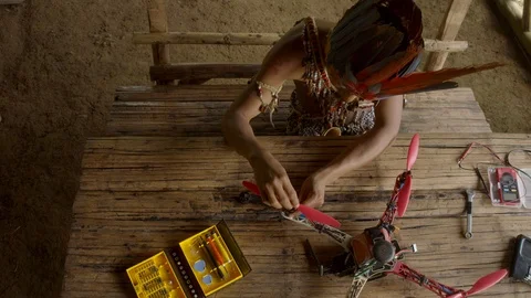 Young indigenous man working on a construction of a drone medium shot camera pan Stock Footage 113179688