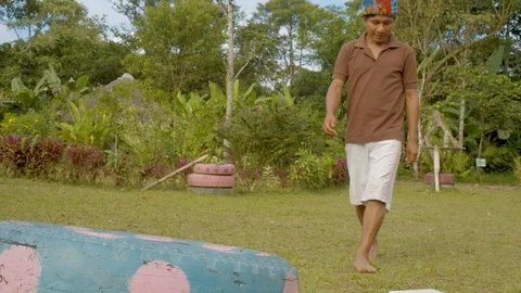 Young indigenous man working on his laptop while he drinks a rainwater from a Stock Footage 113179208
