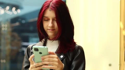 Young individual exploring new technology in vibrant urban setting Stock-Footage 295267390