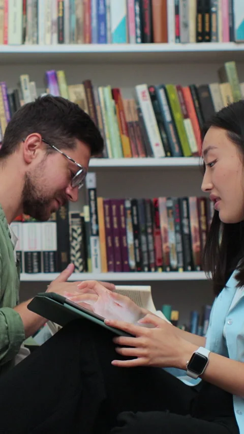 Young individuals studying together using a digital tablet computer. Stock Footage 345148451