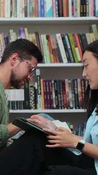 Young individuals studying together using a digital tablet computer. 写真素材