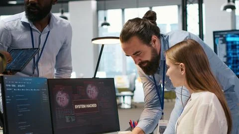 Young inexperienced developer hacked in office requests help from team 库存照片