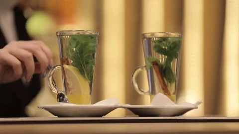 A young inexperienced waiter does not know how to serve tea. Stock Footage 82082767