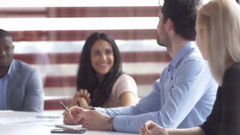 Young innovative workers sitting at the table and collaborating on a project Stock Footage 73857100