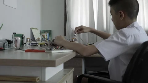 Young Innovator Working on Electronics Project at Desk Video stock 318863394