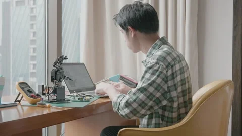 Young Innovator Working on Robotics Project at Desk Stock Footage 338271687
