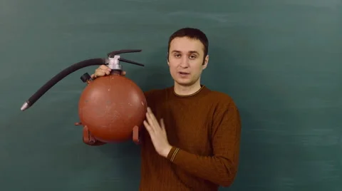 The young instructor explains the functional use of the fire extinguisher. Stock Footage 68684987