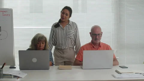 Young Instructor Helping Seniors during Computer Class Stock Footage 263700875