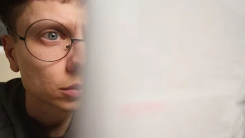 Young intellectual man reading a book with space for text overlay, symbolizing Stock Footage 303140845