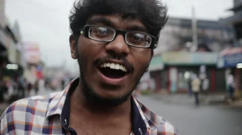 Young intelligent indian man walking on street in slow motion Video stock 60003377