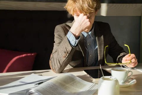 Young intelligent man rests of doing work or university project assignment at Fotos Stock