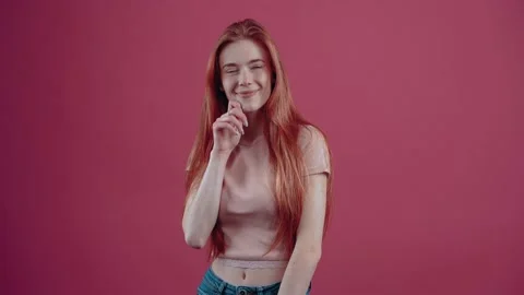 The young intelligent redhead with a smile is thinking of new solutions for Stock-Footage 150896924