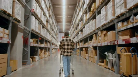 A young Interior designer man pushing supermarket cart looking for home decor Stockbeeldmateriaal 190091573