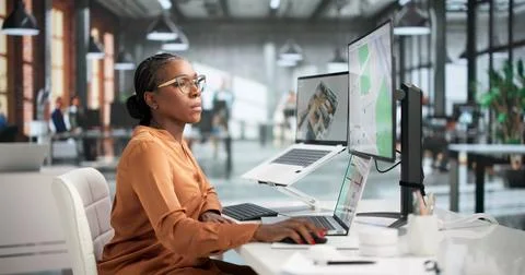 Young Interior Designer Using Computer To Create Virtual Home Layout Plans. Stock Photos