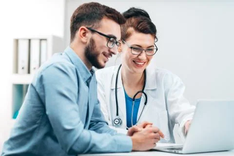 Young Intern at the Hospital Completes Task Stock Photos