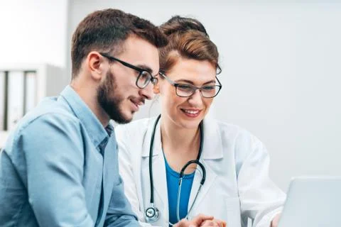 Young Intern at the Hospital Completes Task Stock Photos