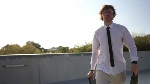 Young intern walking to his first internship carrying laptop and briefcase Stock Footage 346362637