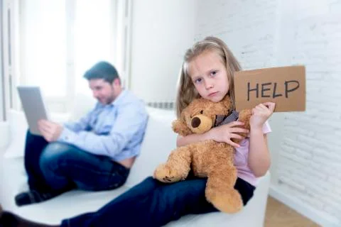 Young internet addict father using digital tablet  ignoring little sad daughter Stock-Fotos