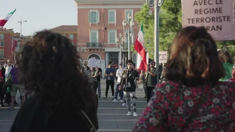Young Iranian guy holds flag at street protest in support of Iranian women 動画素材 219945508