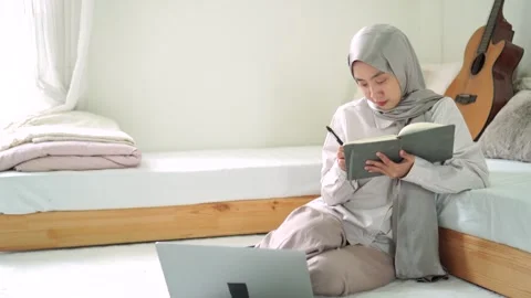 Young islam female learn study write book notebook laptop homeschooling Stock Footage 299179585
