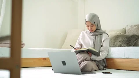 Young islam women learn study writing book researching laptop homework Stock Footage 299179859