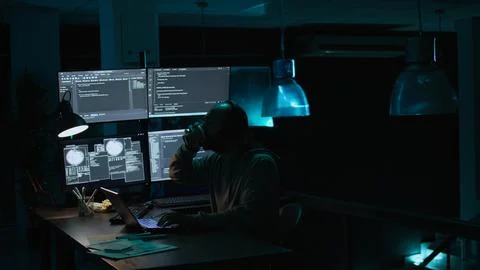 Young IT coder yawning and working on new interface Stockfoto's