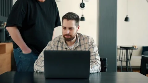 A young IT guy communicates with the director about the project, shows the re Stock Footage 173475222