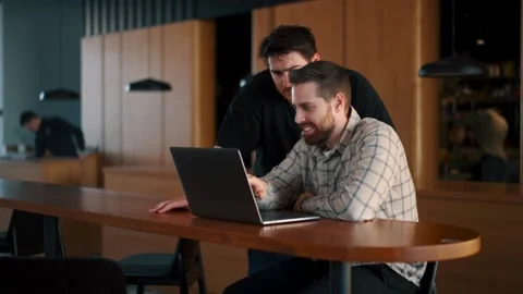 A young IT guy communicates with the director about the project, shows the re Stock Footage 173479203