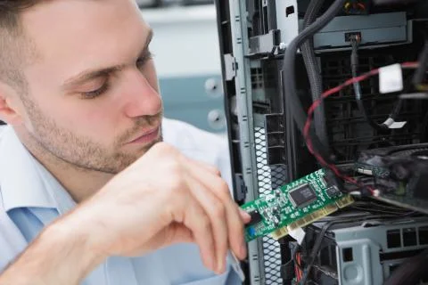 Young it professional fixing computer problem Stock Photos