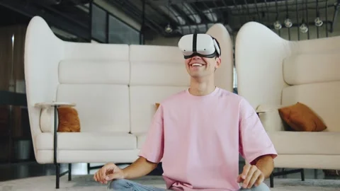 Young IT professional using virtual reality headset in modern indoor space while Stock Footage 330688751