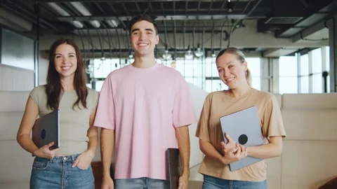 Young IT professionals pose together in a modern office space during a work Stock Footage 330690717