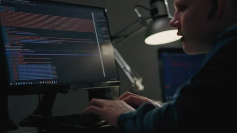 A young IT programmer works remotely in the room of his housing apartment. P Stock Footage 241690519