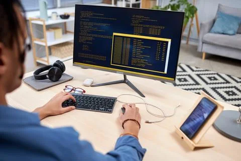 Young IT programmer writing code for mobile devices at home office workplace Stock Photos